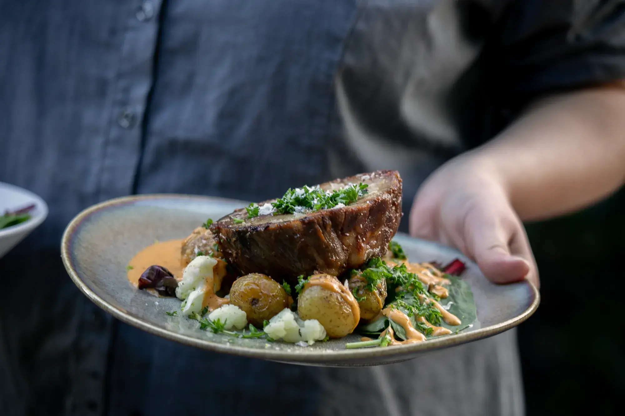 A lunch dish with meat, potatoes and green vegetables
